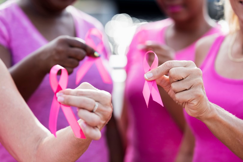 Women holding a pink ribbon