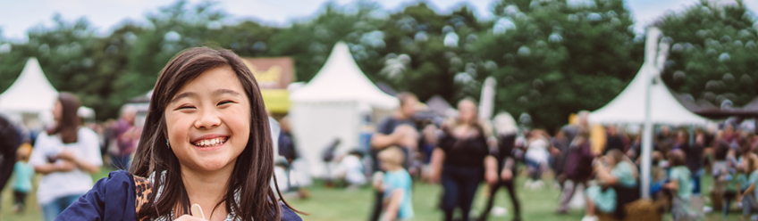 A young girl smiling at an event