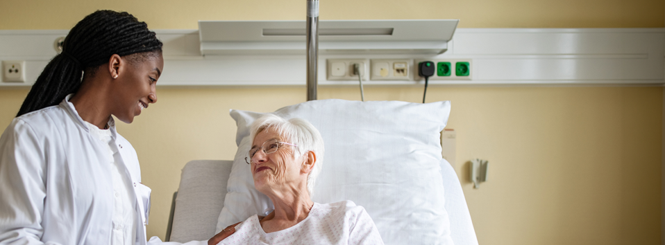 A doctor talking to an elderly patient